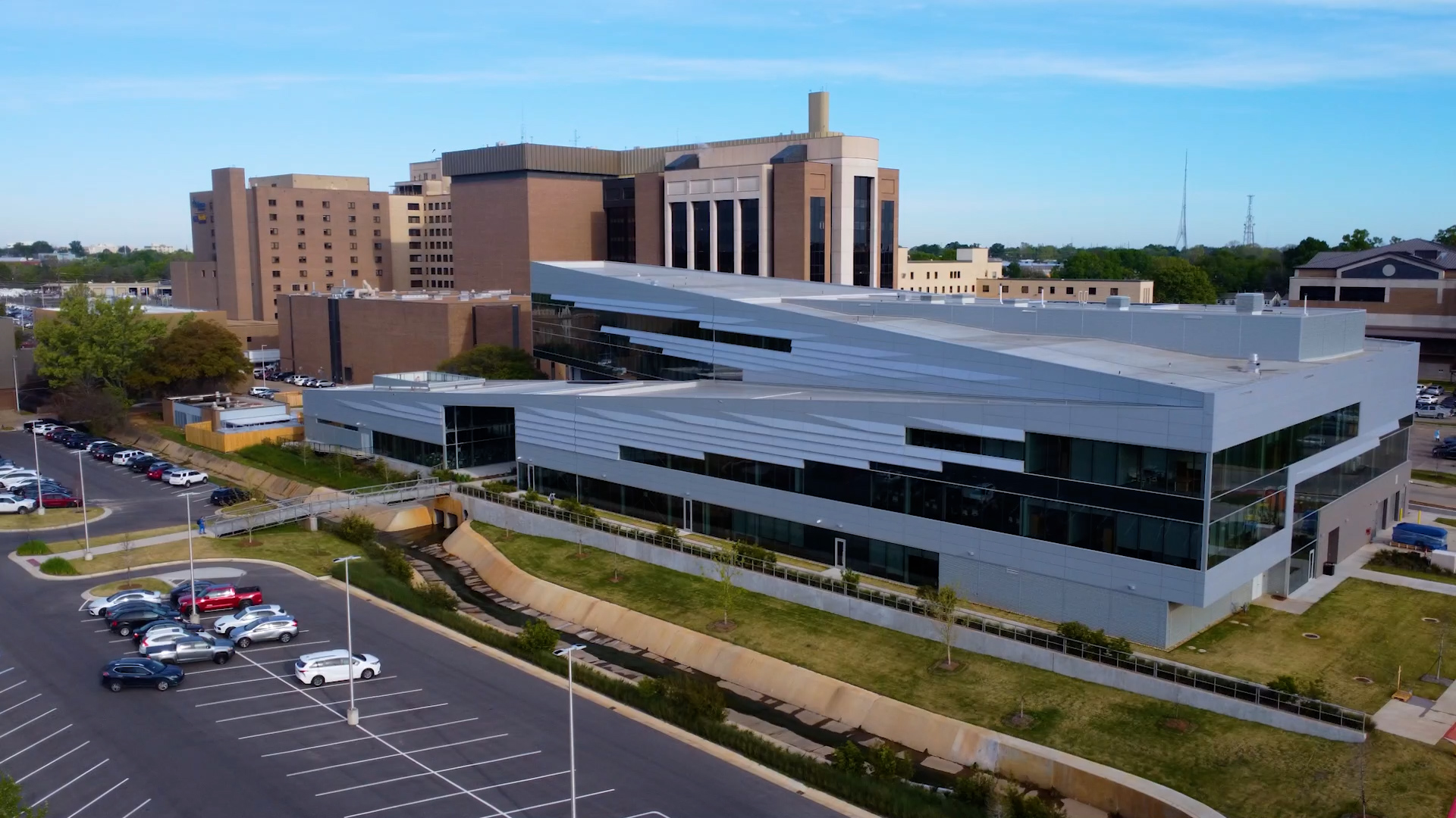 Aerial view of the LSU Medical Education Building's modern glass and steel exterior, set against the surrounding LSU Health Shreveport campus.